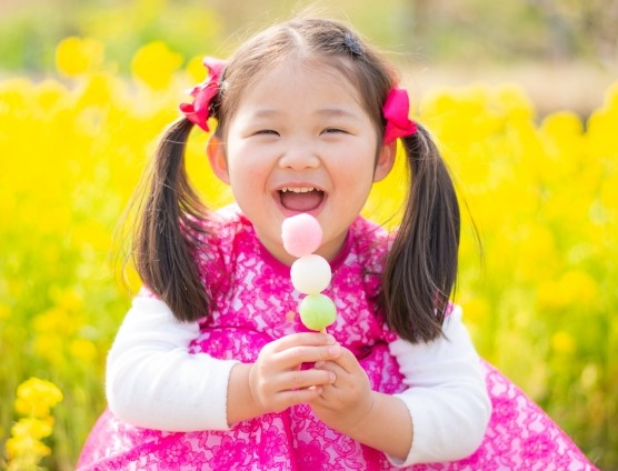 Girl holding a "dango" in her hand