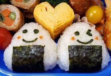 Two onigiri with faces drawn on them